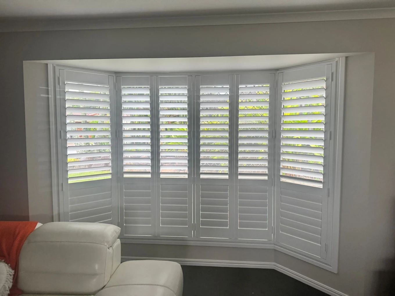 Bay window with white plantation shutters installed